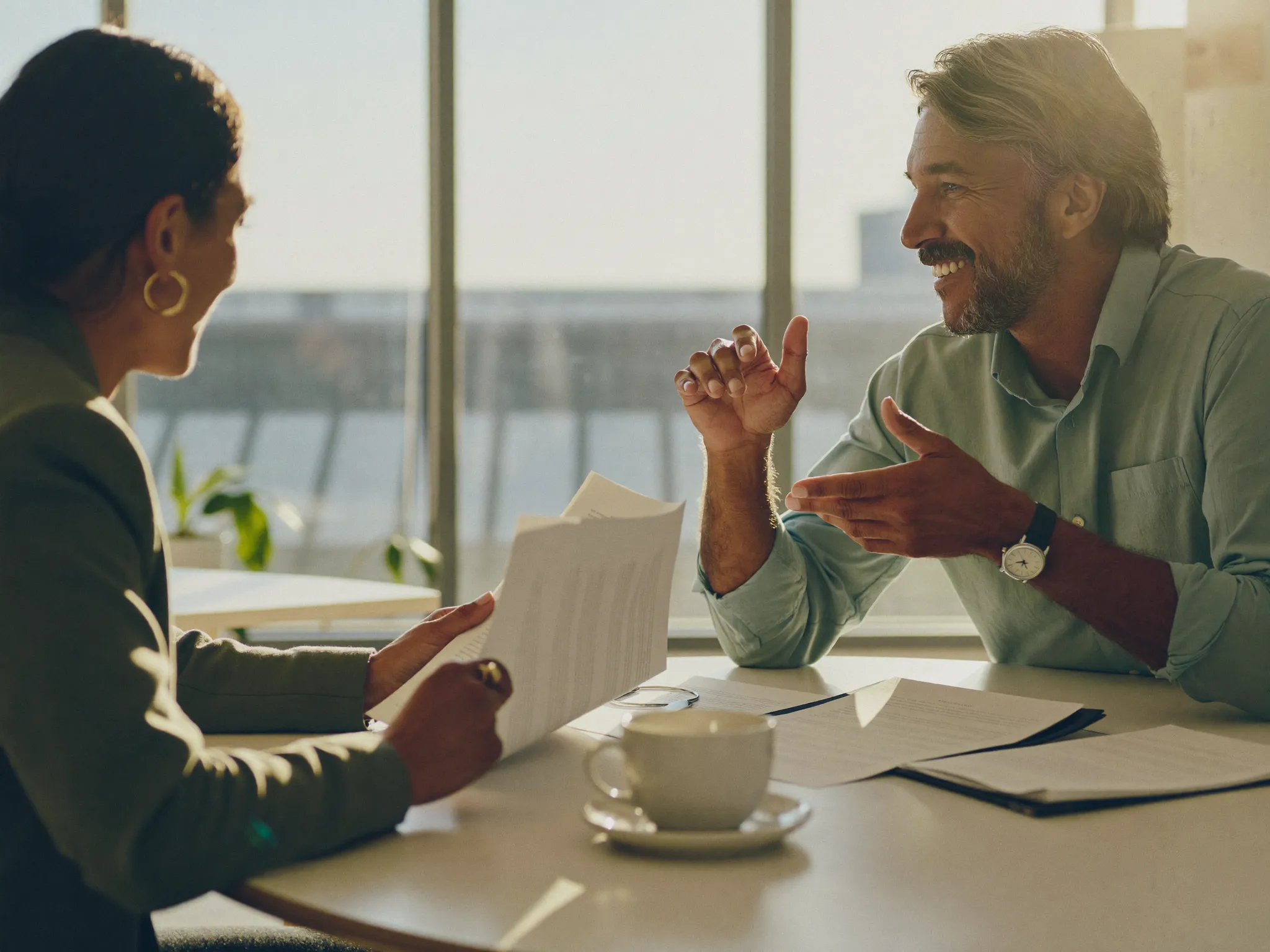 Two professionals discussing their interview experiences